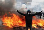 Chaos in Paris: Riots, burning cars and clouds of tear gas
