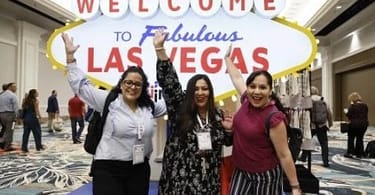 IMEX America attendees pose in front of a Welcome to Las Vegas sign. image courtesy of IMEX | eTurboNews | eTN
