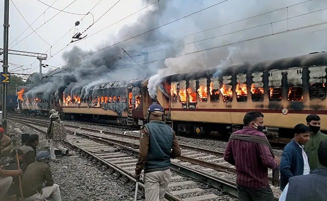 Angry mob burns trains in India over rigged railway exam