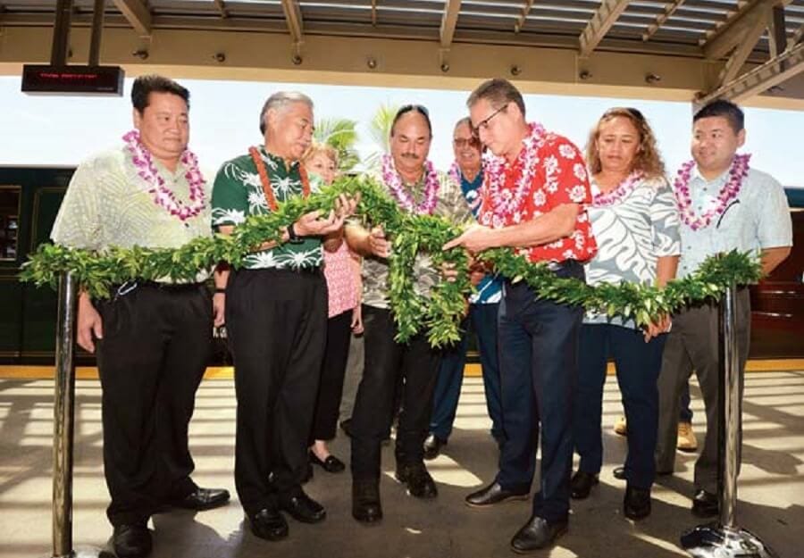 Dignitaries-look-on-as-Gov.-David-Ige-second-from-left-Maui-Airports-District-Manager-Marvin-Moniz-and-Hawaii-Senate-Majority-Leader-J.-Kalani-English-untie-a-maile-lei-during-dedication-ceremony